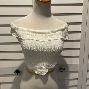 Naked Wardrobe NWOT Crop Top in a Polyester/Rayon/Spandex blend.